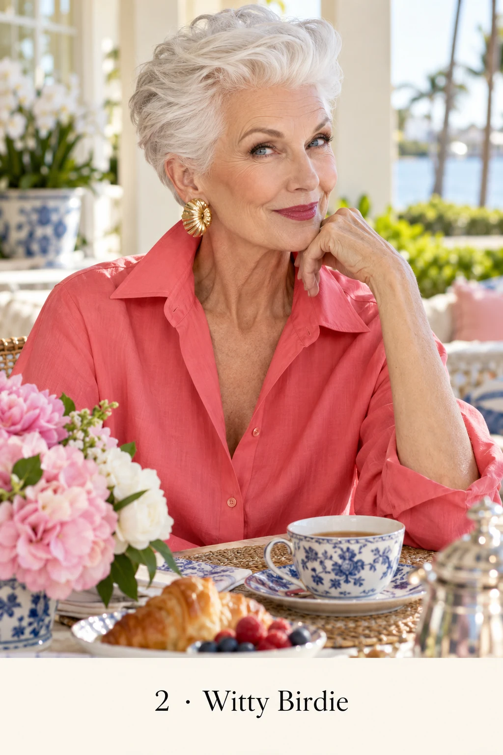 Birdie with a knowing smile, silver hair, and gold earrings at her sunny breakfast table